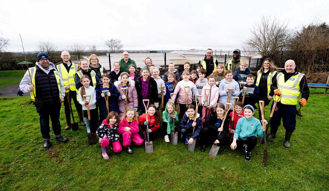 Schoolchildren and moy park staff planting trees